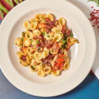 Orecchiette · Shell shaped pasta, smoked bacon, green peas, fresh tomato, garlic, and olive oil.