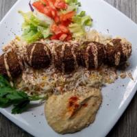 Falafel Platter · Classic falafel plate. Placed on a bed of aromatic rice. Plate comes with a pita bread, crea...