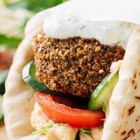 Falafel Wrap · Classic falafel wrap. Comes with hummus and veggies. Topped with our tahini-based flame sauc...