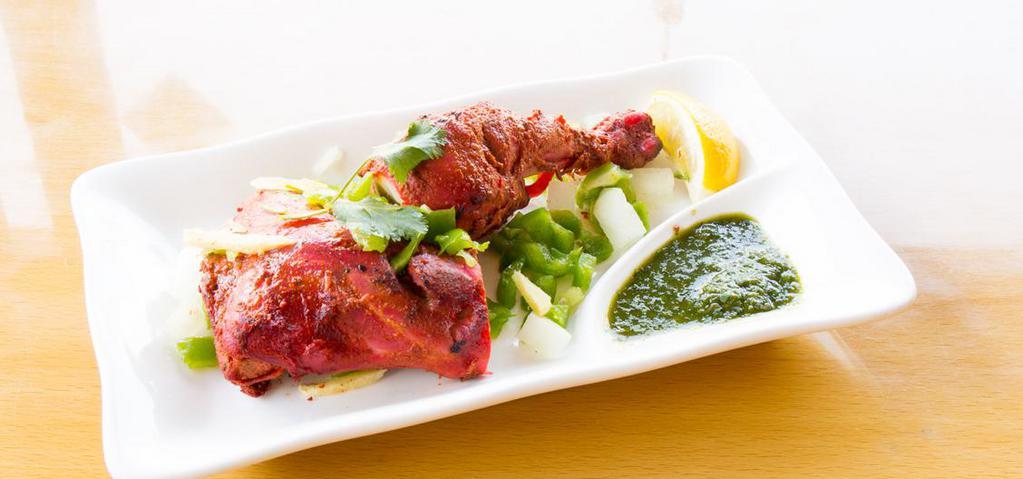 Tandoori Chicken  1 -1/2 leg only · 1 1/2 small leg or 1 big leg only marinated in yogurt and spices and baked.
