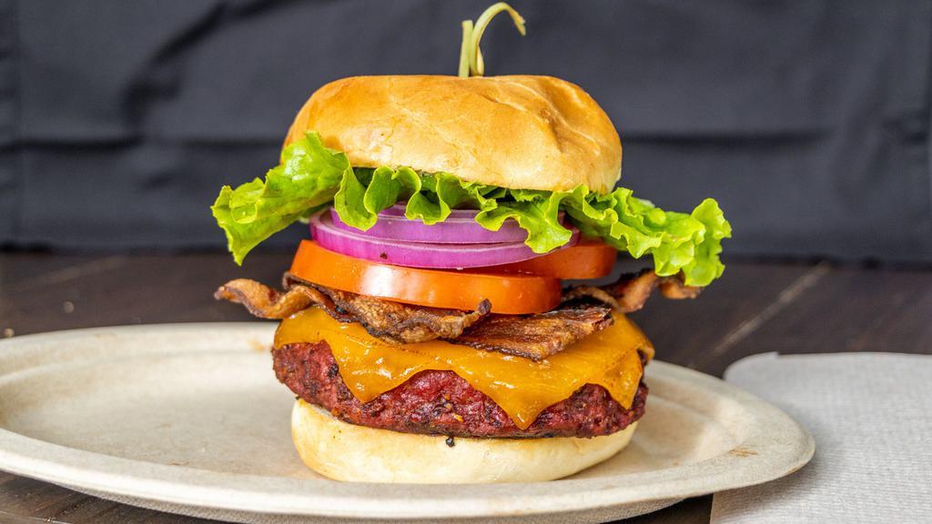 Bacon Cheeseburger · 1/2lb of Black Angus Ground Brisket, 2 Slices of Smoked Bacon, Two Slices of Cheese, Tomatoes, Onions and Lettuce, Our Own Red Dirt Sauce all on a Brioche Bun