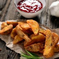 Potato Wedges · Fried Potato Wedges seasoned with cajun spice