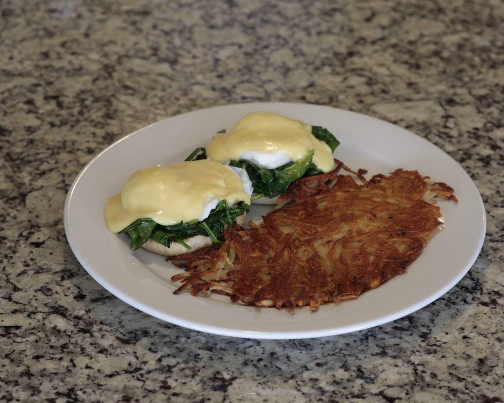 Eggs Florentina · Poached eggs and fresh spinach with hollandaise sauce on an English muffin.