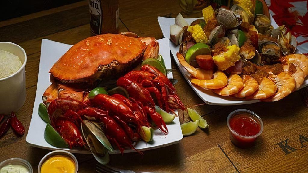 C4 Combo · 1 Dungeness Crab or 1 Lobster, 1 lb shrimp, 1 lb clams, 1 lb crawfish (frozen), 2 corns, 2 potatoes, and 4 sausage.