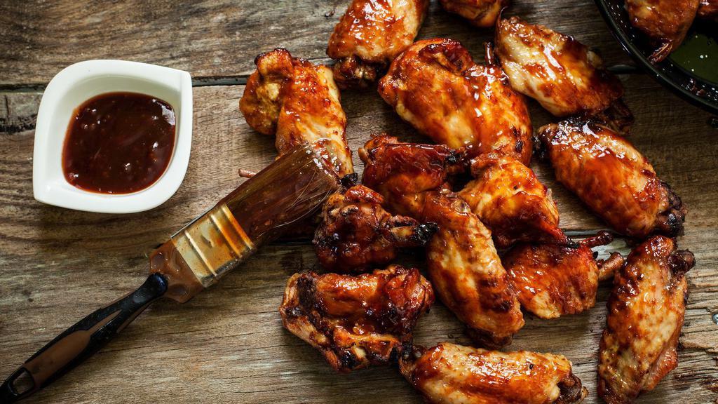 The BBQ Wings · Golden, crispy, perfectly fried wings glazed with smoky, sweet BBQ sauce.