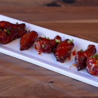 Korean BBQ Wings · Mary's natural chicken wings tossed in hot and sweet korean gochujang sauce and sesame seeds.