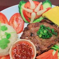 Grilled Pork Chop Plate (Com Tam Bi Cha Suong Nuong) · Served with broken rice (com tam), shredded pork, Vietnamese egg meatloaf (cha), salad, and ...