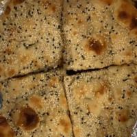 #11. Roghni Naan · Flat leavened on the wall lining of tandoor oven with sesame seeds.
