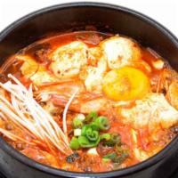 Kimchi Soft Tofu · Soft-tofu boiled with kimchi. Served with a side of rice and a side of raw egg.