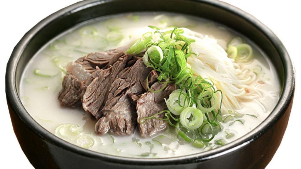 Chadol Komtang · Ox bone broth served with brisket and noodles. Soup made with ox bones by simmering on a flame.