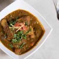 Himali Chicken Curry · Bone in chicken cooked in an onion based sauce w/ fresh tomatoes, herbs, and homemade spices...