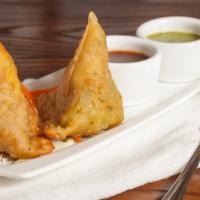 Vegetable Samosa · Hand wrapped, deep fried triangular pastry filled with spiced potato, peas and served with m...