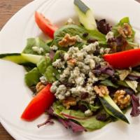 Sultana Salad · Mixed green salad with tomatoes, cucumbers, walnuts and blue cheese, tossed in a lemon juice...