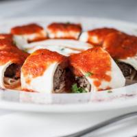 Beyti Kebab · Seasoned minced lamb and beef grilled and rolled in lavash bread, topped with fresh tomato s...