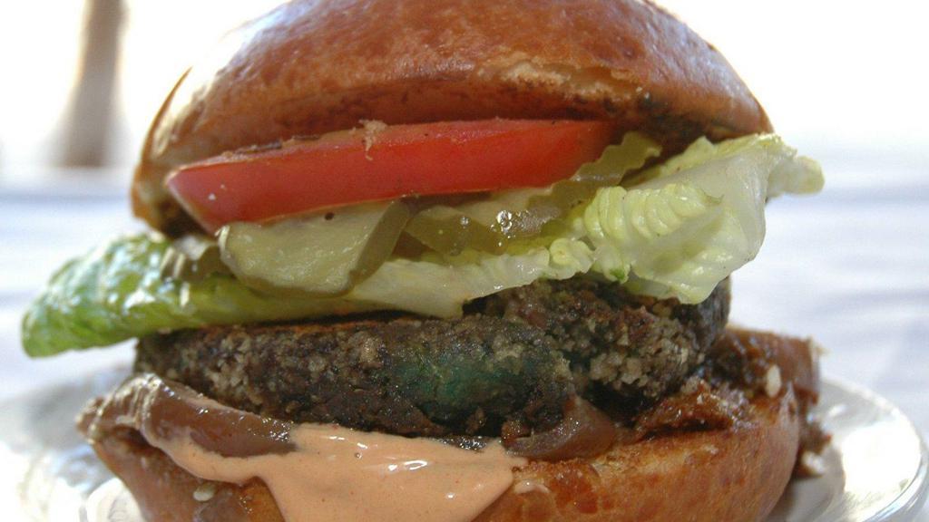The Sydney Burger · Our vegetarian burger with a black bean porcini cutlet, caramelized red onions, chipotle remoulade, lettuce, tomatoes, and pickles.
