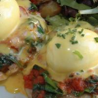L'accademia Poached Eggs · Two poached eggs with spinach, tomato and Hollandaise sauce on English muffins, served with ...