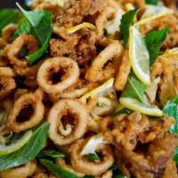 Basil Fried Calamari (ปลาหมึกทอด) · Gluten-free. Lightly battered calamari tossed with Thai Basil and jalapeños  served with swe...
