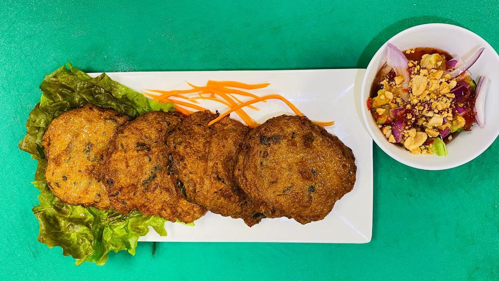 Fish cake · Ground fish mixed with a house made curry  paste, served with chunk cucumber in sweet chili sauce and peanut 0n top