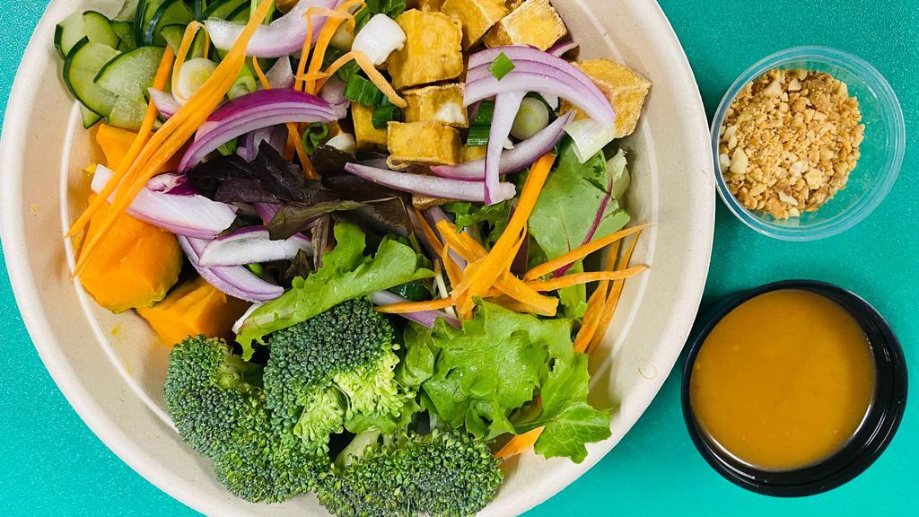 Tofu & veggie bowl · Fresh mixed greens, pumpkin, broccoli , scallion, cucumber and topped with fried non GMO tofu  and peanut salad dressing