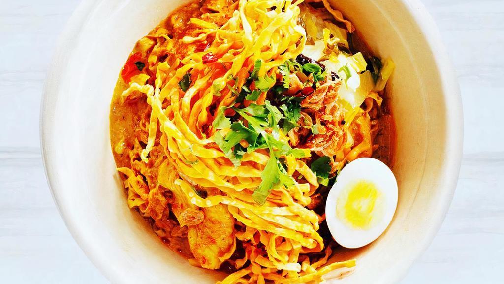 Kao Soi (ข้าวซอย) · Vegan-friendly. Egg noodles in curry broth and boiled free-range egg topped with fried onion pickled mustard greens, bean sprouts, and crispy noodles.