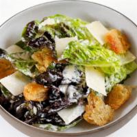 Little Gem Caesar · Classic dressing, torn garlic croutons, and grated Parmesan.