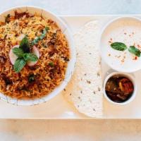 Saffron Chicken Biryani · fragrant basmati rice slow cooked with   chicken and house spice blend cooked   “Dum Pukht” ...