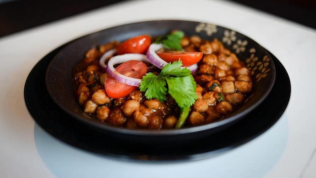 Channa Masala · delicious garbanzo beans, onions,   tomatoes, cooked with green chilies   and a touch of garam masala