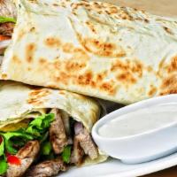 MEAT PITA SANDWICH AND WRAPS · Boneless Beef or Lamb cooked with spices.  Stuffed in Pita with Hummus, Israeli salad, Pickl...