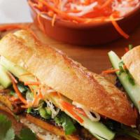 VEGAN BANH MI  (V) · Tofu, Pickled carrots, onions, cucumbers, cilantro and lettuce on a baguette bread spread wi...