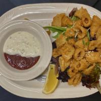 Fried Calamari · Light and crispy calamari dusted with parmesan cheese. Served with cocktail and tartar sauce.