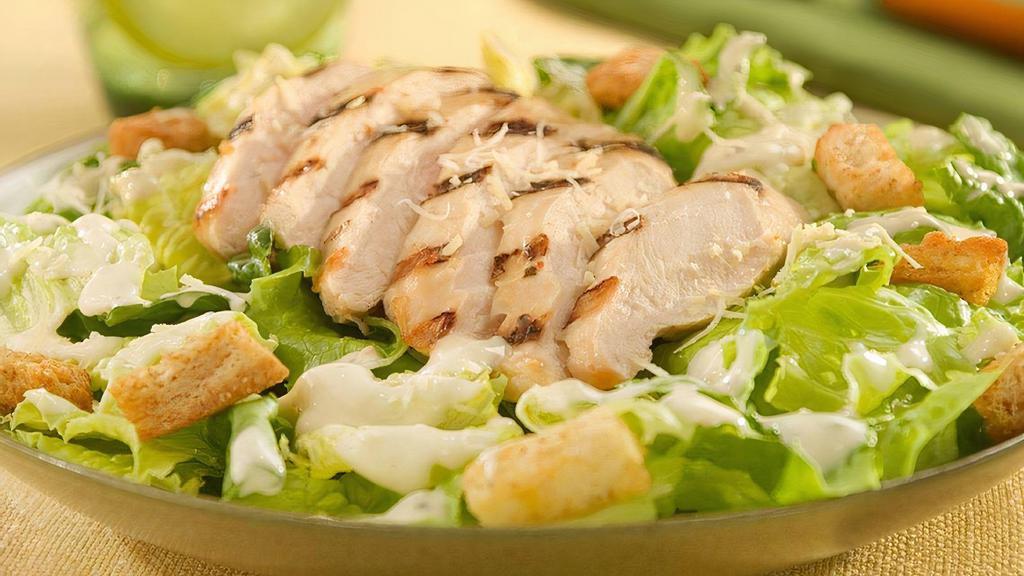 Chicken Caesar · Grilled chicken breast on top of crisp romaine, tossed with creamy caesar dressing, croutons, and parmesan cheese.