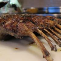 New Zealand Rack of Lamb · Rubbed with special herbs and spices, then roasted and brushed with demi-glaze.