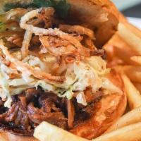 Pulled BBQ Brisket Sandwich · Pulled BBQ Brisket on a burger bun with cole slaw, crispy fried onions, and cilantro. Served...