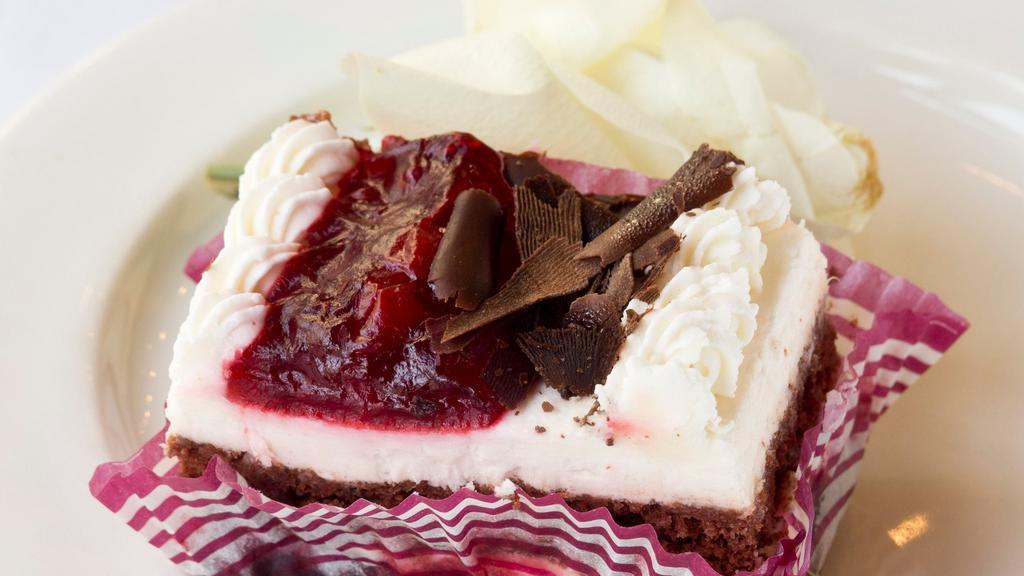 Black Forest · Cherries and whipped cream between two layers of chocolate cake. Topped with more whipped cream, cherries, and chocolate shavings.