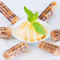 Churros · Deep-Fried sweet dough rolled in cinnamon and brown sugar, served with vanilla ice cream.