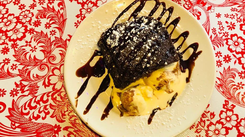 Pastel Azteca · Rich moist chocolate cake with Mexican chocolate sauce, served with vanilla ice cream.