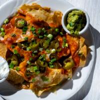 Nachos · Classic nachos with a generous portion of our fresh homemade chips smothered with melted che...