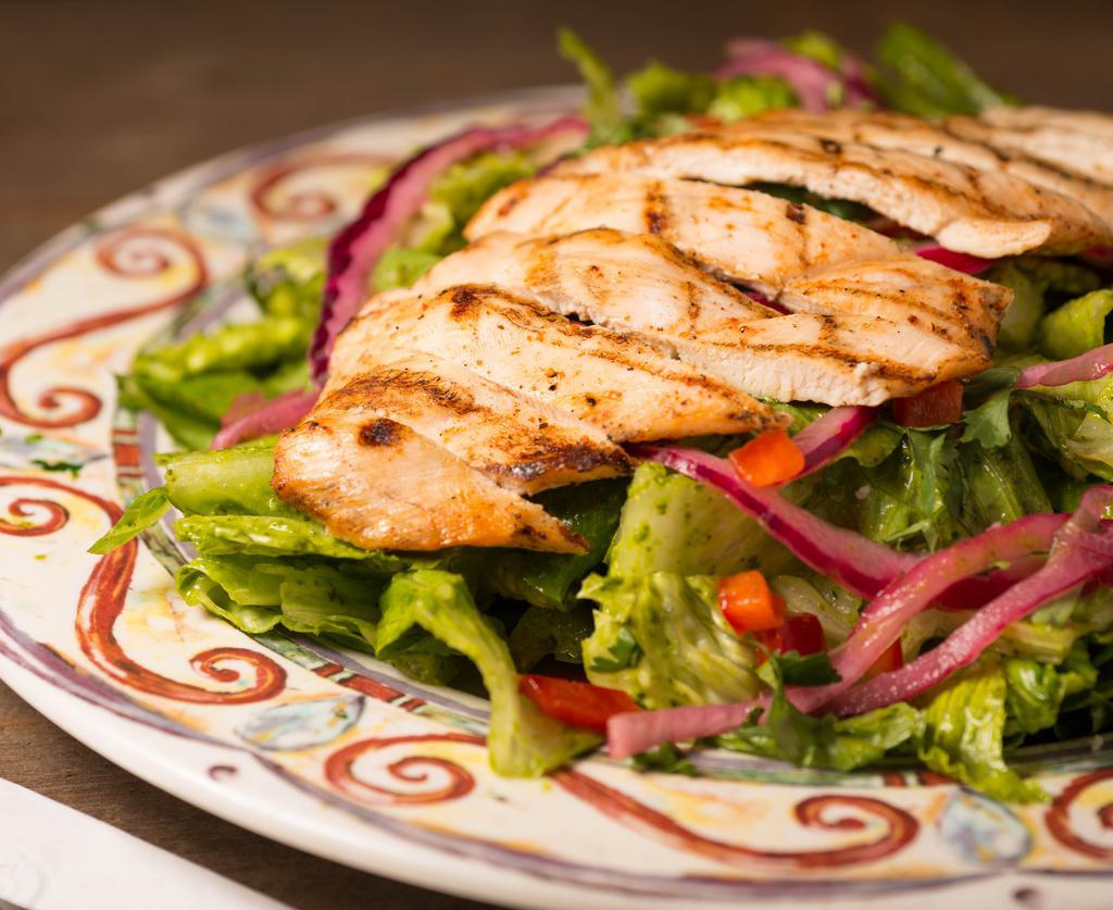 Cilantro-Lime Salad · Chopped romaine lettuce tossed in our own homemade cilantro lime dressing topped with shredded chicken breast, cebolla desflemada (lemon-tamed red onion) and red bell pepper.