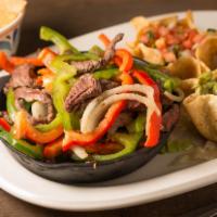 Fajitas · Strips of tender steak, chicken breast or a combination of both sautéed with spices, bell pe...