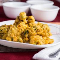 Assorted Vegetable Pakoras · Vegetables dipped in chip-pea batter and deep fried.