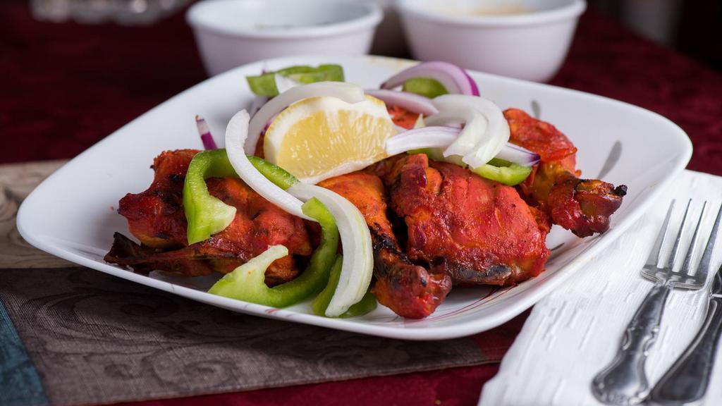 Tandoori Chicken · Leg piece marinated in yogurt and spices and roasted.