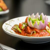Chicken Tikka Masala · Boneless white meat chicken cooked in tandoor and cooked in a creamy tomato sauce.
