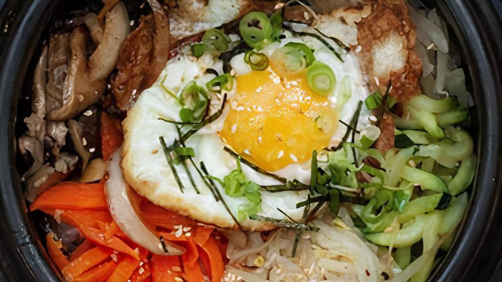 Vegetable Bibimbap · Steamed rice spinach bean sprouts carrots mushrooms zucchini daikon dried seaweed and egg.