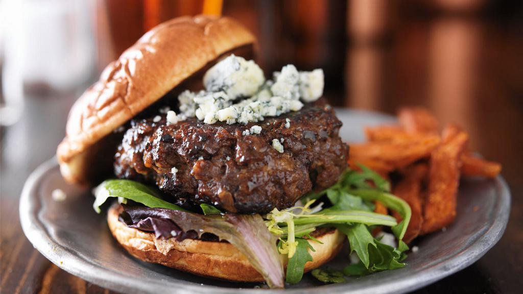 The Black & Blue Burger · Juicy 1/3 pound grilled beef burger with grilled onions, blue cheese crumbles and crispy Applewood smoked bacon, served on a buttered toasted bun with fresh lettuce, tomato and roasted garlic aioli.