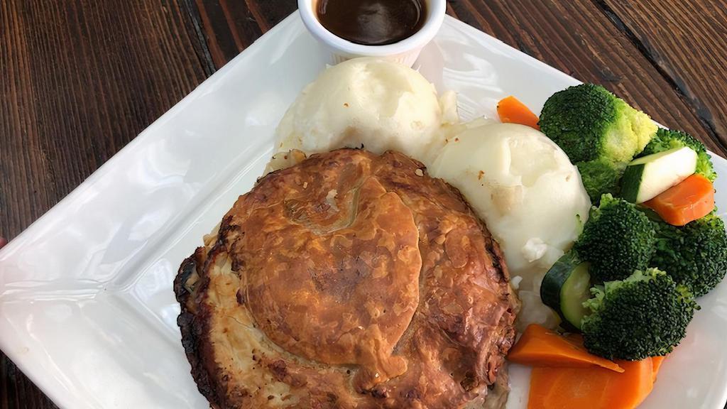 Chicken Mushroom Pie · Tender chunks of chicken and mushrooms in a white wine herbed gravy in a flaky pastry. Served with mashed potatoes, veggies and brown gravy.