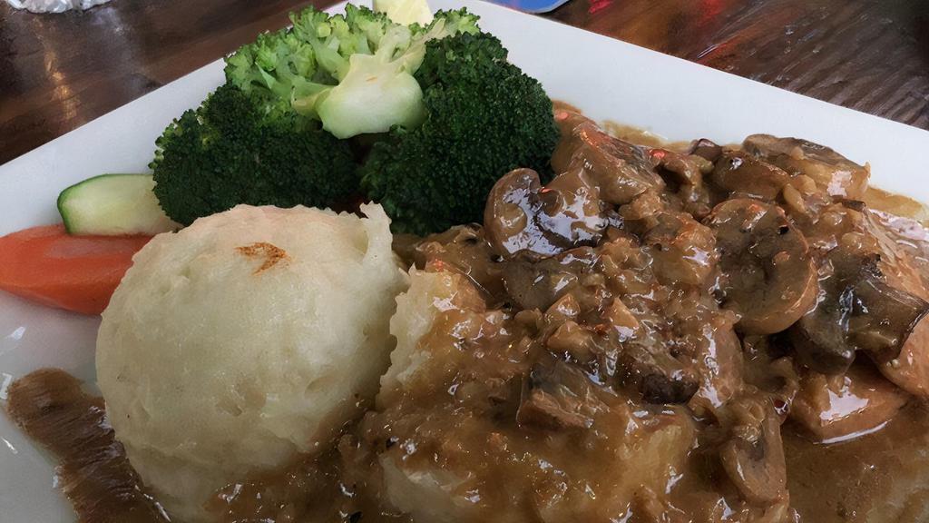 Chicken Marsala · Chicken breast sauteed with marsala wine cream sauce and mushrooms. Served on mashed potatoes and veggies