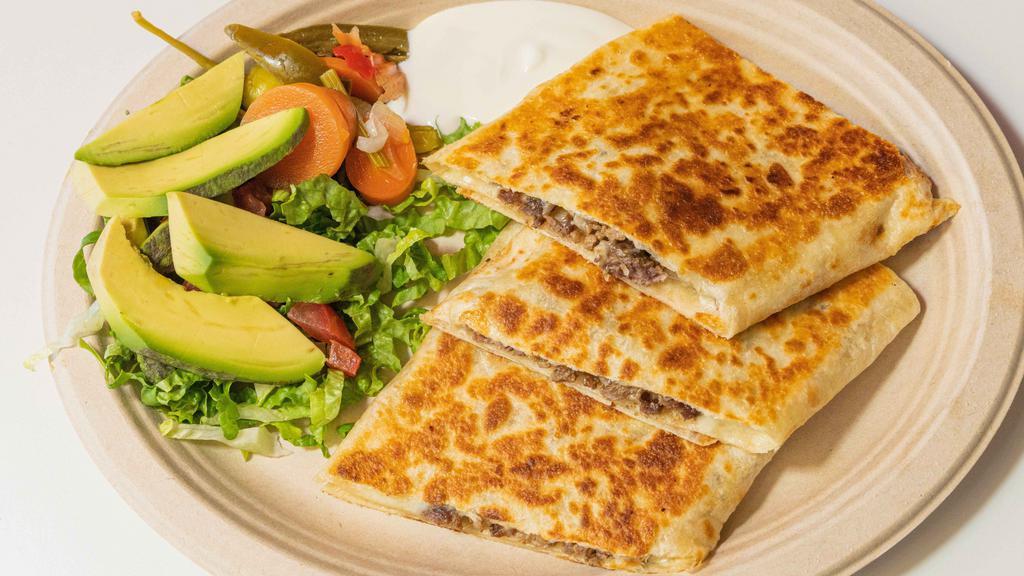 Quesadillas · Cheese and meat of your choice, a side of Lettuce, tomato, Sour cream, Carne que elijah y queso con lechuga tomate y crema y aguacate alado.
