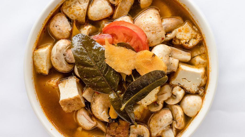 33. Tom Yum · Thai's hot and sour soup in tomato, mushrooms, ginger basil and kafir leaves, with a choice of meat or vegetarian.