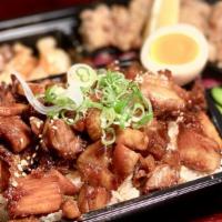 Chashu Pork Bento · Tender chashu pork over rice, edamame, takoyaki, soft-boiled egg*, fried gyoza, fried chicken