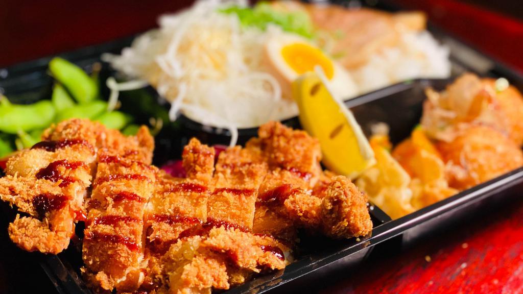 Chicken Katsu Bento · Chicken cutlet, edamame, takoyaki, soft- boiled egg*, fried gyoza, shredded cabbage, tender chashu pork over rice